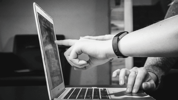 person using laptop black and white photo